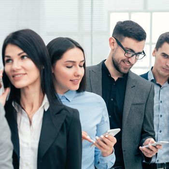 close up. a group of diverse business people using their smartphones