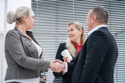 close up. business partners shaking hands at an office meeting. business concept