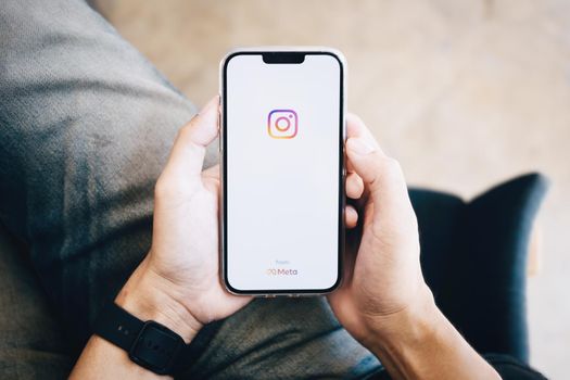 CHIANGMAI, THAILAND - Nov 07, 2021: A man holding smartphone with Instagram application on the screen. Instagram is a photo sharing app for smartphones