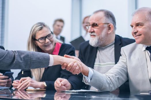 close up. business partners shaking hands at the negotiating table. the concept of cooperation