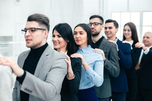 group of corporate employees standing behind each other. the concept of teamwork