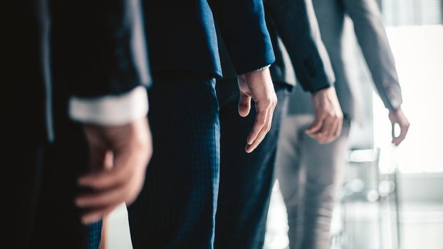 close up. office employees passing through the office. business concept