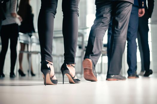 close up. a variety of business people passing through the office business center. business background