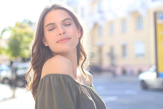 Smiling happy young beautiful woman walking outdoors