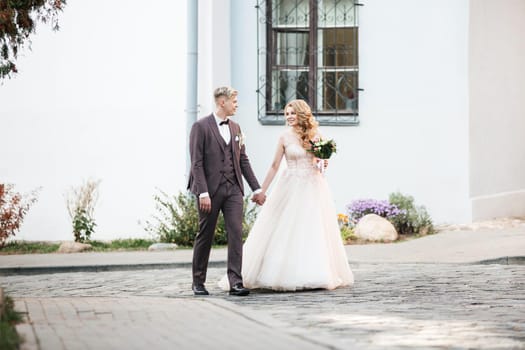 happy newlyweds passing through the city street . photo with copy space