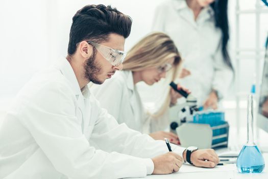 close up.the scientist writes data to the log. science and health