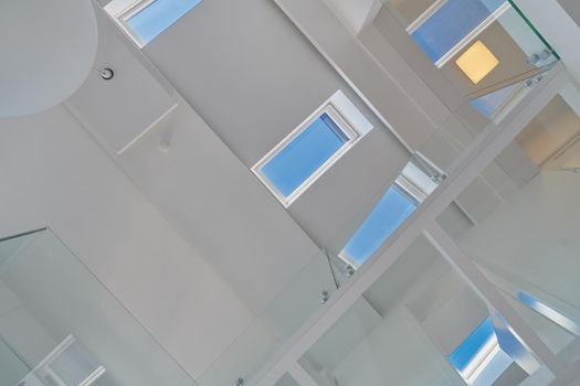 Automatic remote White skylight roof windows in a loft with white walls