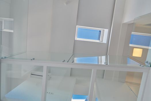 Automatic remote White skylight roof windows in a loft with white walls