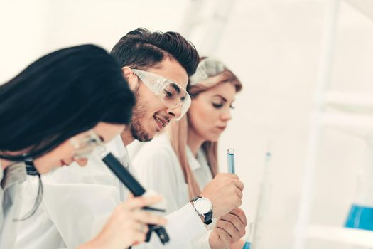 close up.a group of young scientists conduct experiments in the laboratory. science and health