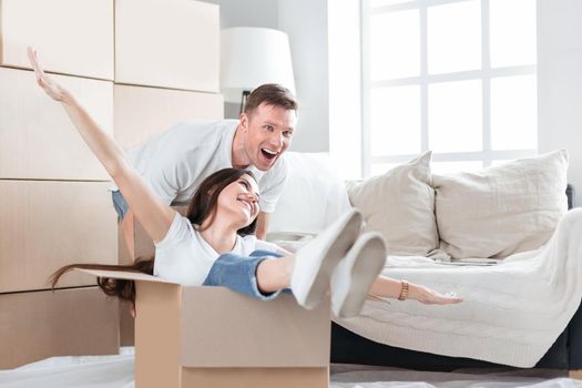 close up. happy husband and wife having fun in their new apartment