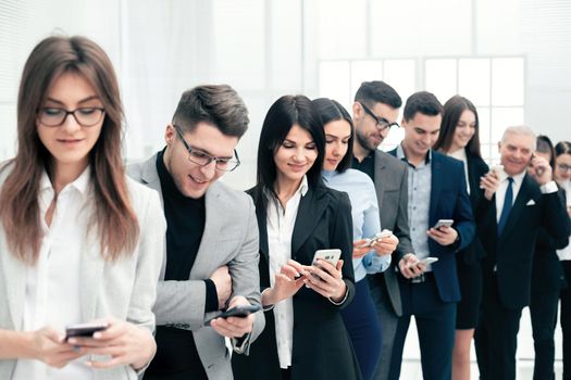 close up. a group of young people reading messages on their smartphones