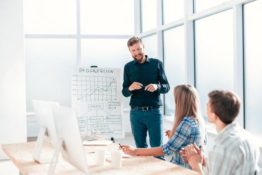 project Manager explaining to employees the new strategy of the company . photo with copy space