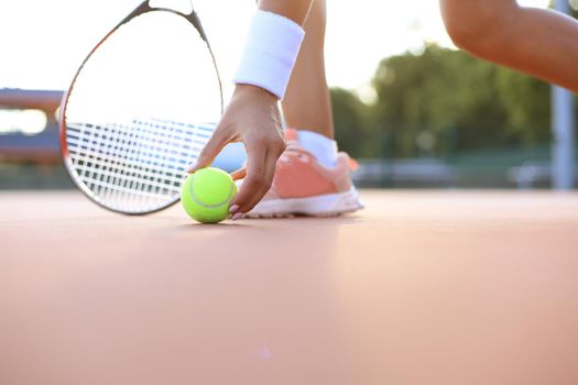 Tennis racket and the ball on tennis court