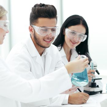 close up.a team of scientists sitting at the laboratory table . science and health