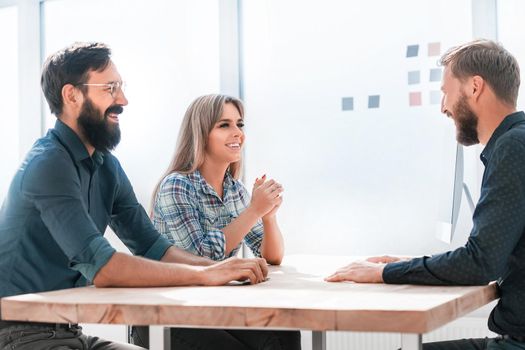 group of young employees sitting at the Desk. office weekdays