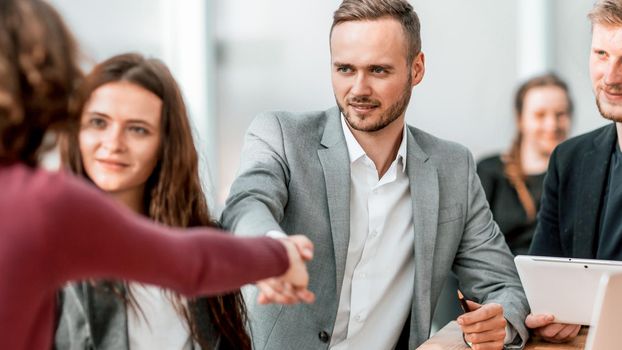 close up. young businessman shaking hands with his business partner . concept of cooperation