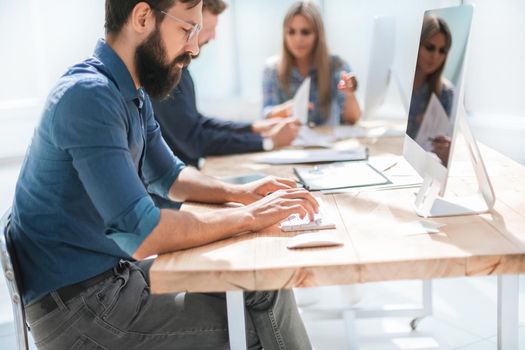 businessman uses a computer in the workplace in the office. people and technology