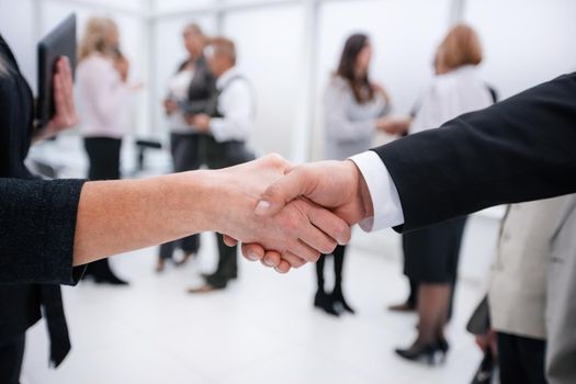 close up. businessman and businesswoman shaking hands . business concept
