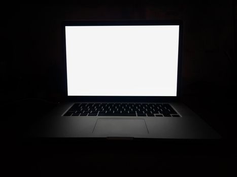 close up. open laptop with blank screen on dark background