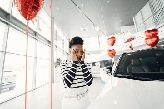 Went shopping today. Shot of an attractive African woman shooses a car.