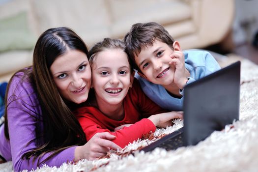 happy young family with mom and kids have fun and play in modern new living room home indoor