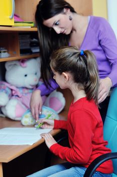 happy family woman and girl working on homework at home while mom showing globe and giving help