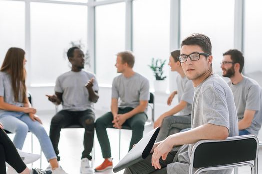 handsome guy sitting in a circle with like-minded person. business and education