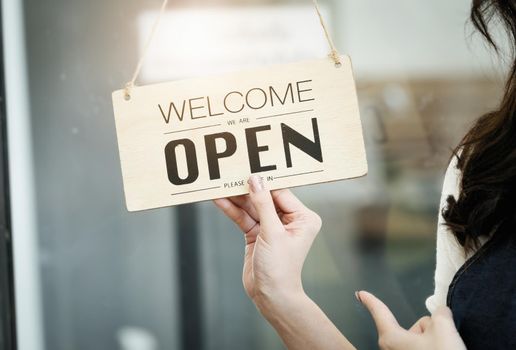 Startup stores, small business owners Standing to display a sign at the reception for customers who will come to use the service in the shop after the coronavirus situation began to unfold