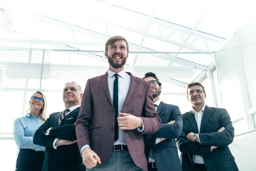 happy businessman with his business team standing in the office . success concept