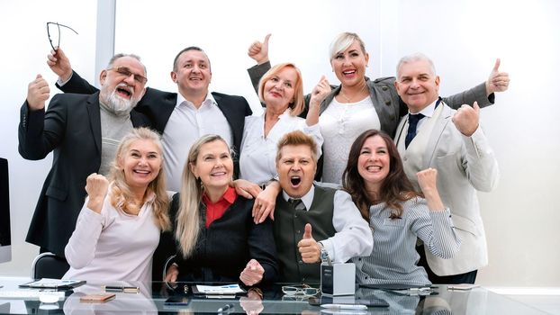 happy group of professional professionals showing thumbs up. the concept of professionalism