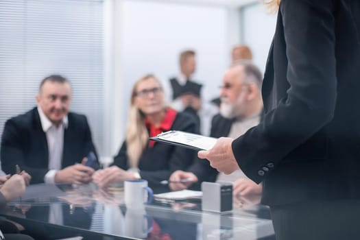 close up. the Manager makes a report at a meeting in the office. business concept