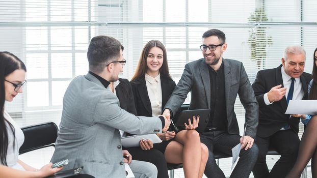 business colleagues shaking hands at an office meeting. concept of cooperation