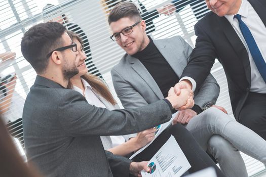 business partners shaking hands at a work meeting. business concept