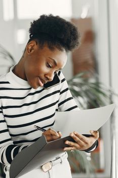 Woman with mobile phone. Lady with documents.