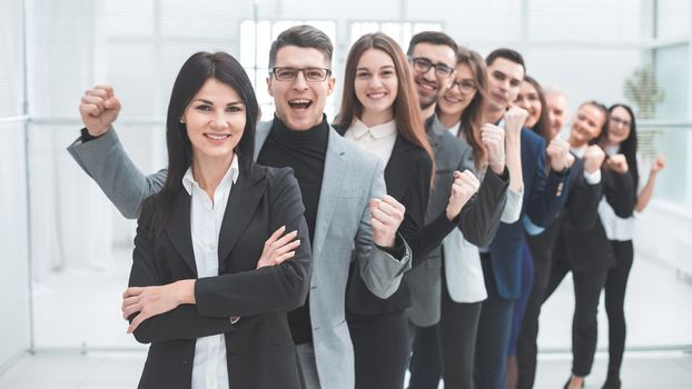 happy group of diverse young people standing in a row . the concept of teamwork