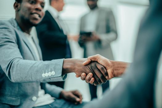 close up. international business colleagues shaking hands with each other