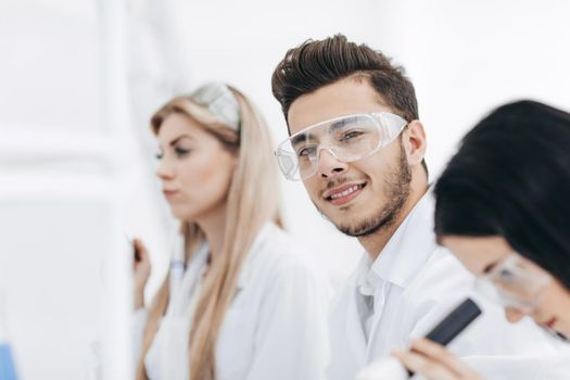 close up.a group of young scientists in the laboratory. science and health