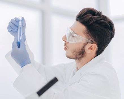 close up. scientist with a medical tube standing in the lab. science and health