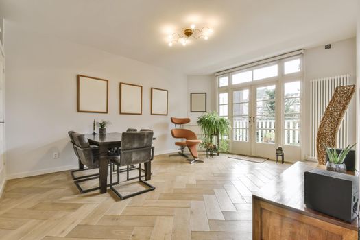 Lovely large dining room with many paintings on the walls