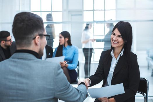close up. businesswoman shaking hands with her business partner. concept of cooperation