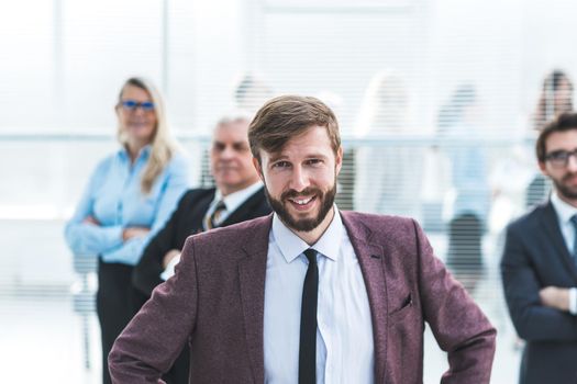 close up. confident young entrepreneur standing in a Bank office