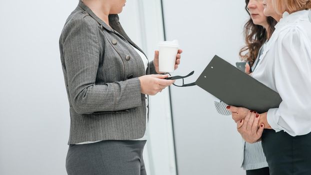 close up. businesswoman discussing with employees working issues. office weekdays