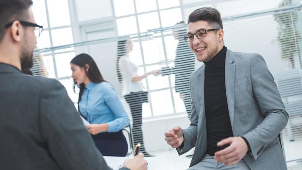 young businessman discussing with a colleague his ideas. office workdays