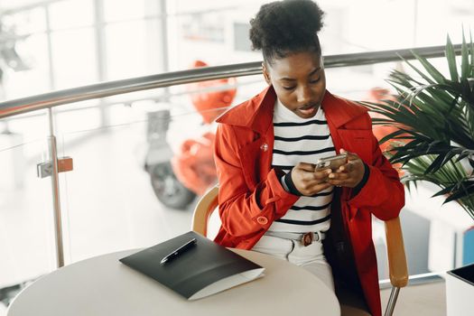 Woman with mobile phone. Lady in red jacket.