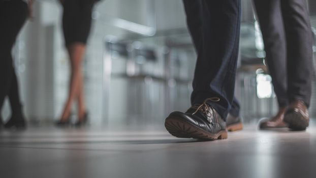 close up. group of employees leaving the workplace. business background