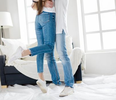 husband and wife hug standing in their new apartment. photo with copy-space