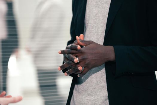 close up. young business man standing near office window