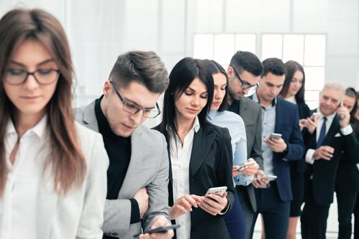 close up. a group of young people reading messages on their smartphones