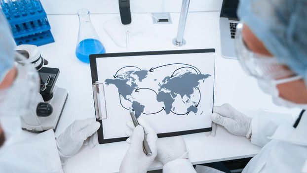 close up. map of the spread of coronavirus in the hands of an epidemiologist. concept of health protection. Elements of this image furnished by NASA