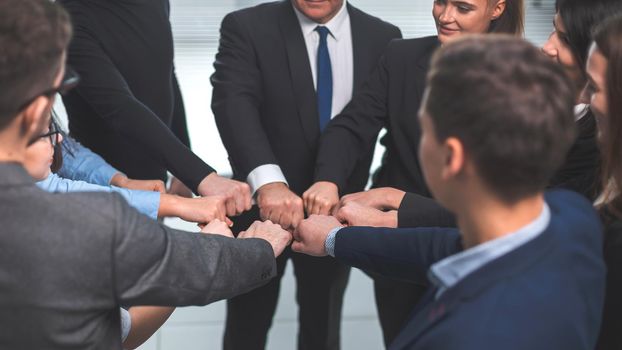 close up. a team of young professionals standing in a circle. the concept of teamwork